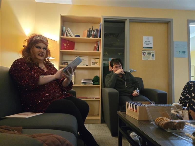 two people in a lounge reading and talking