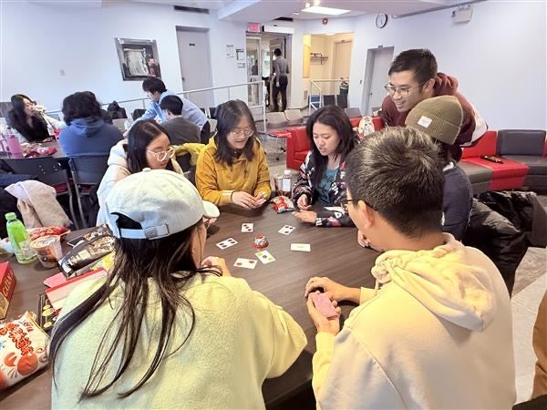 students in a lounger playing a board game
