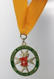 green circle with Renison badge hanging from yellow ribbon