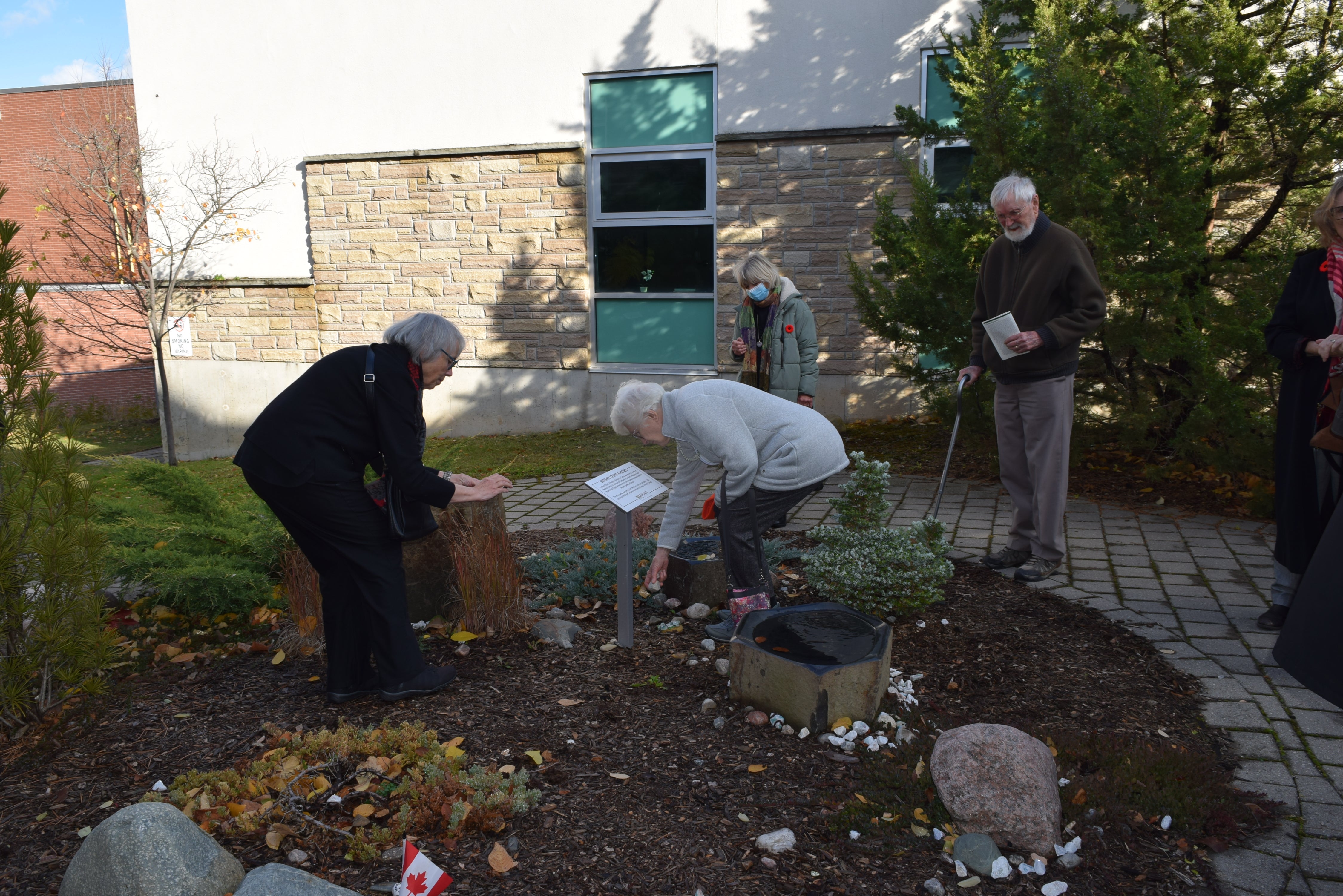 People putting stones in the Bryant Stone Garden