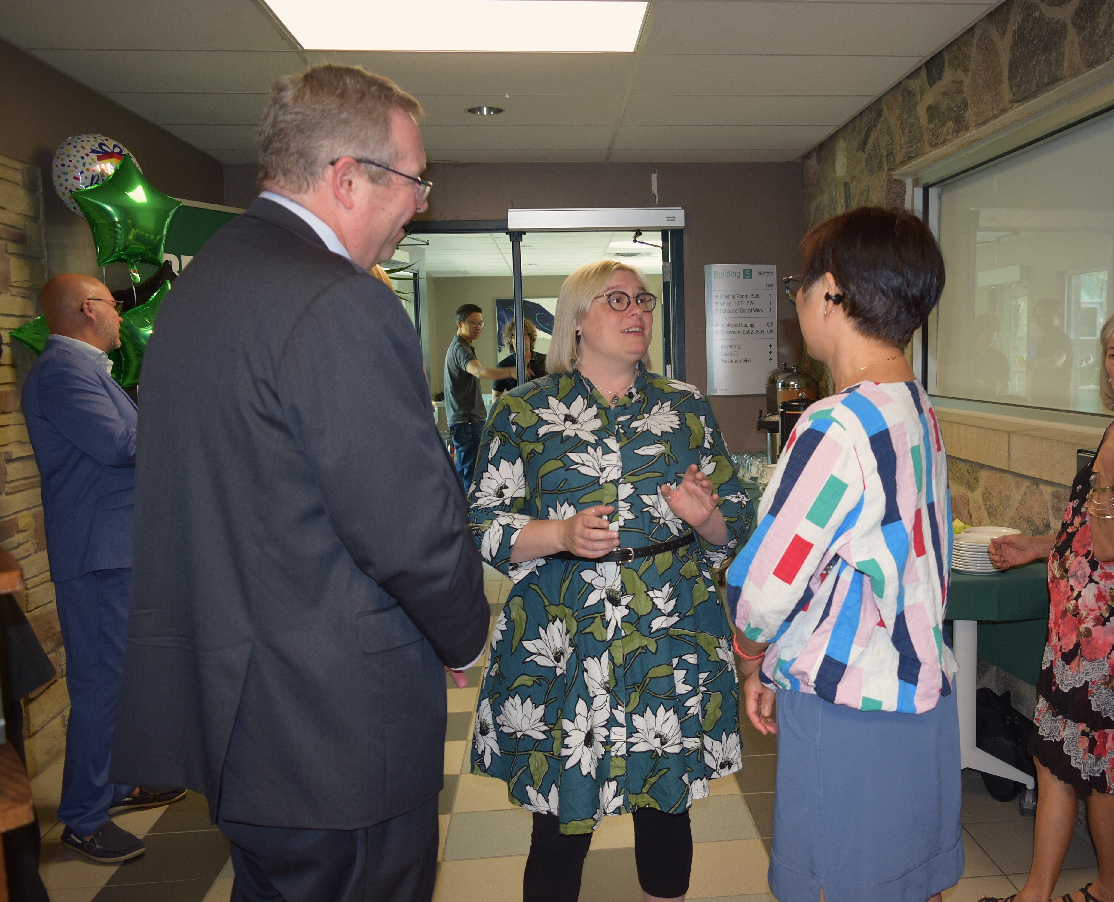 Sue Weare, scholarship recipient, speaks to two other attendees