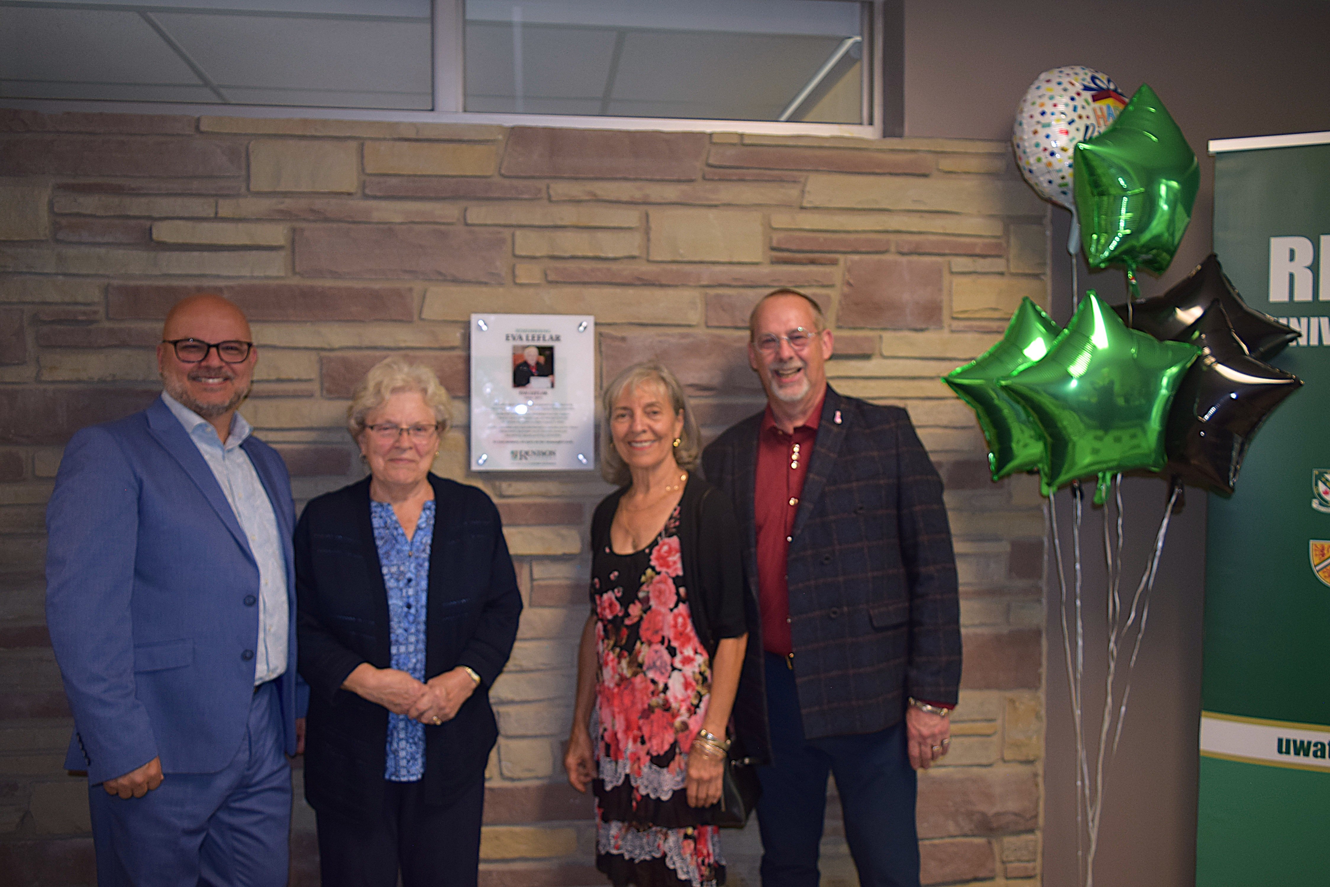 The Eva LeFlar Foundation team posing beside the plaque: Jim Frizzell, Gale Repta, Josie Joseph and Dave Kirkness