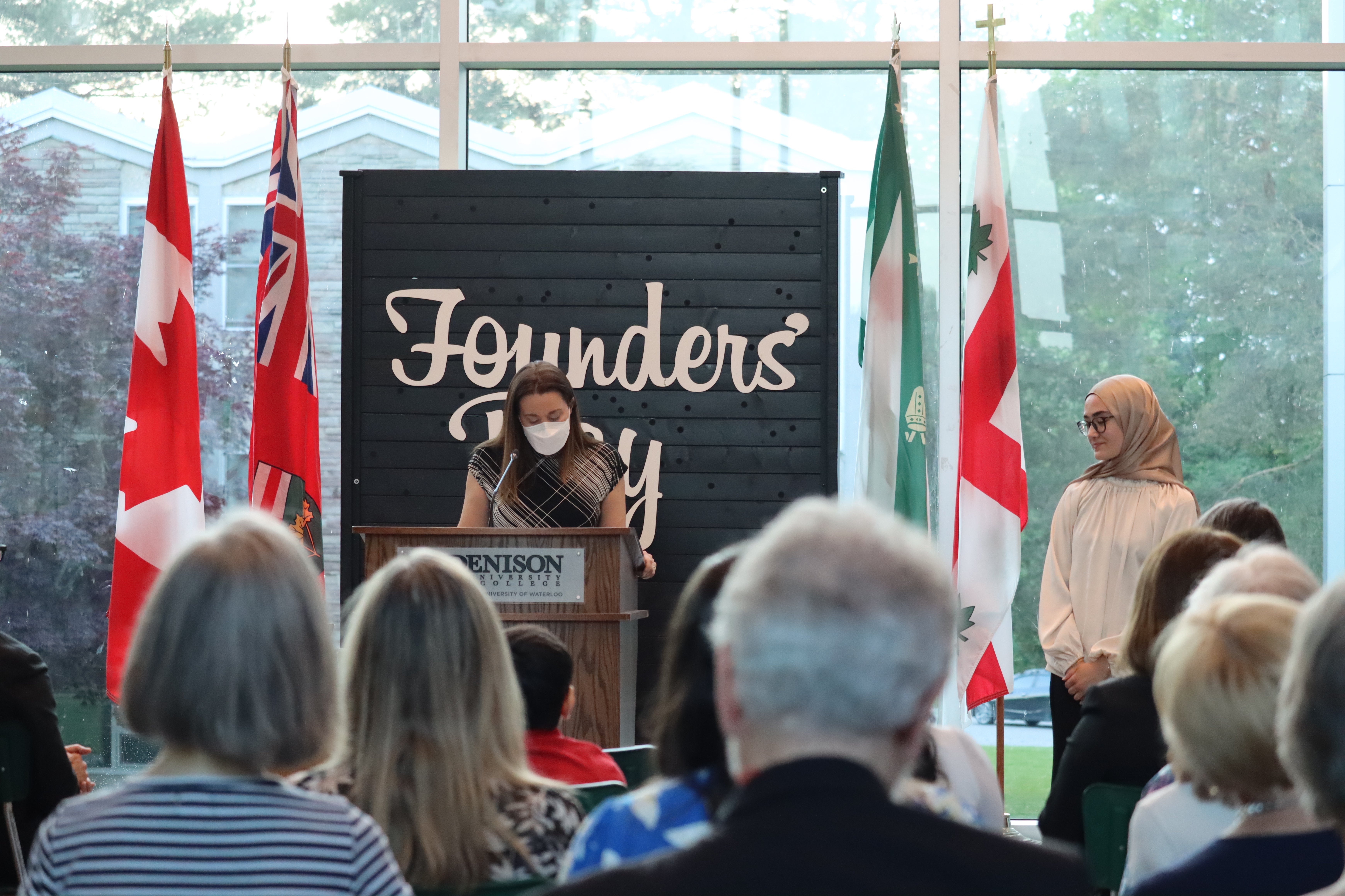 Person at podium in the atrium presents award. 