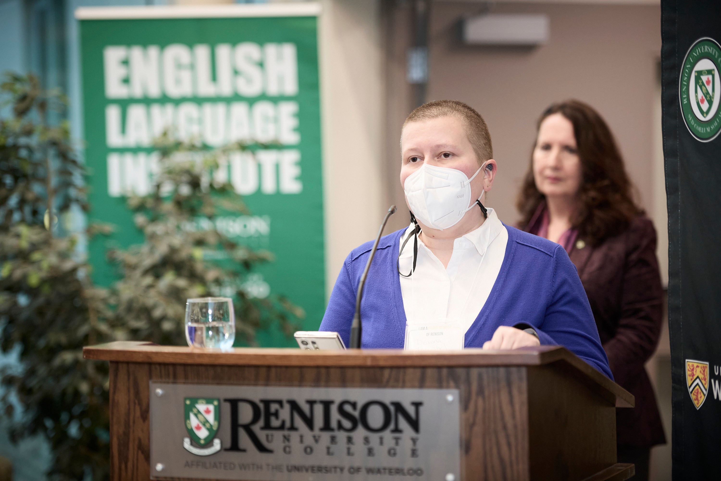 A person gives remarks while wearing a face mask. 
