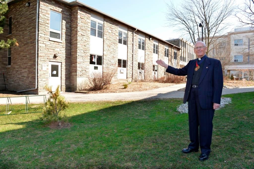 Harvey Southcott gestures to the Founders Building on a visit in 2013
