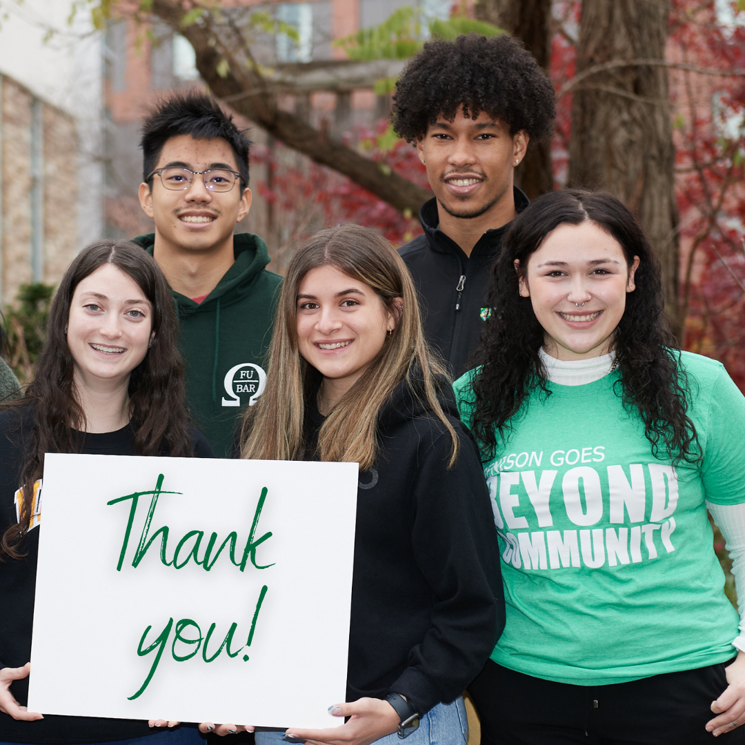 Five students are shown smiling in the courtyard, holding a sign that says thank you