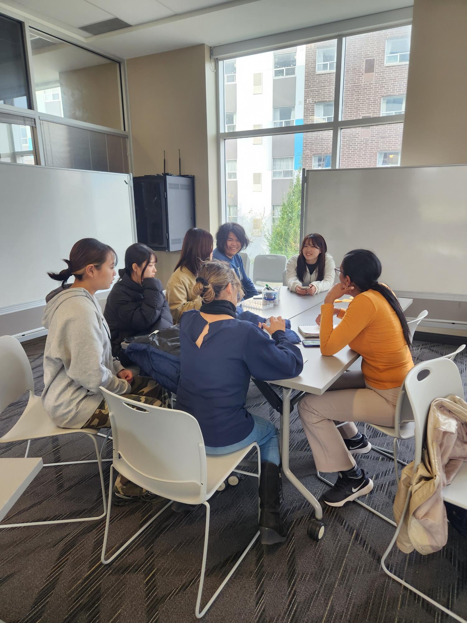 A group of students working together at a table. 