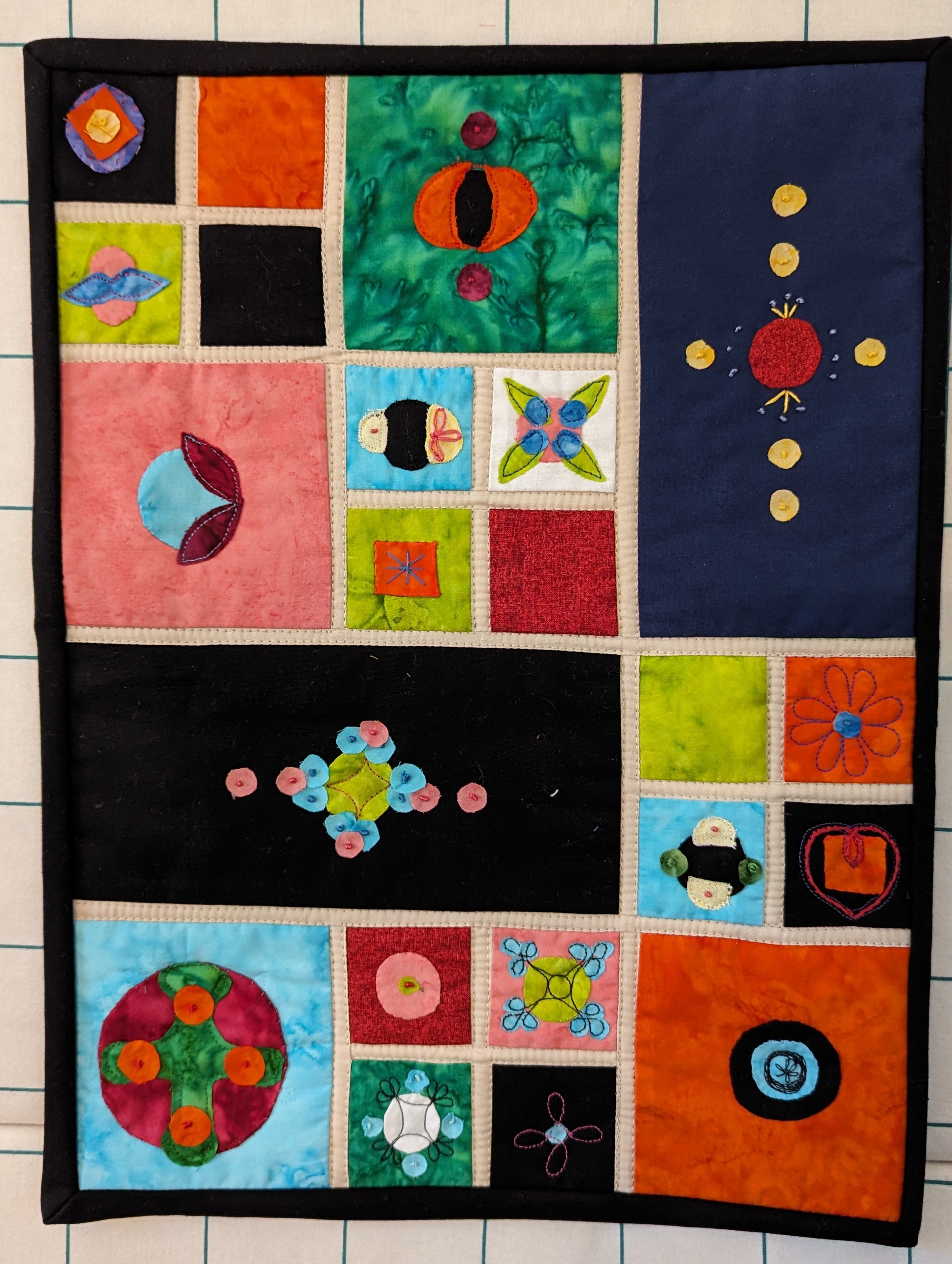 A colourful quilt with varying patterns showing different designs. 