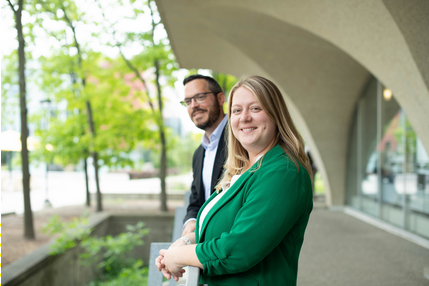 Man and woman smiling near a railing