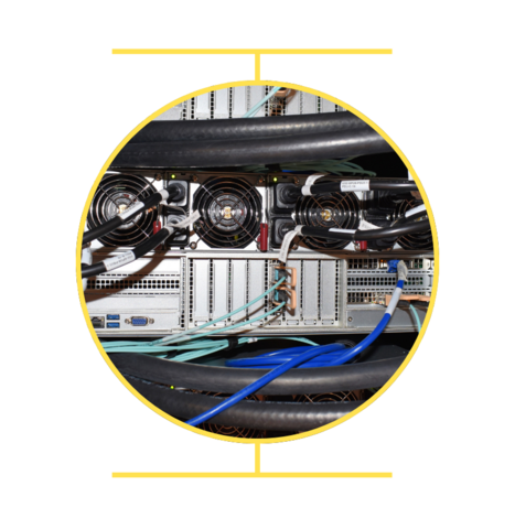 Close up of computer showing cooling fans, teal and blue cables and black tubes 