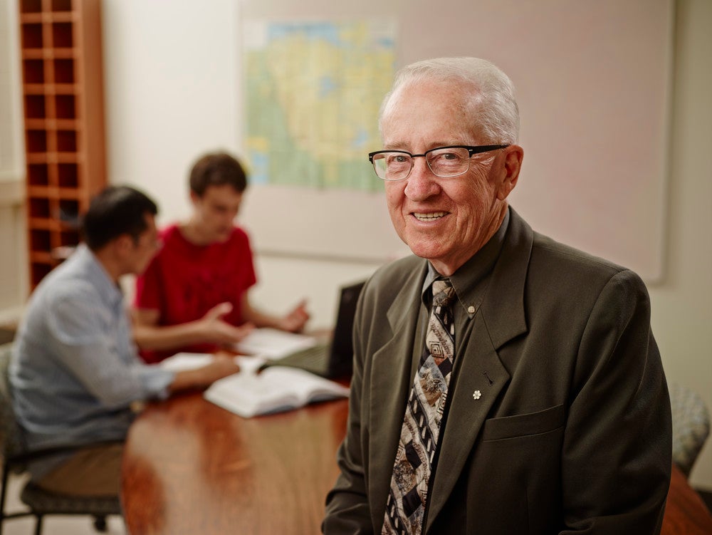 Ralph Haas in a classroom with students in the background
