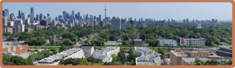 A view of urban green spaces with the Toronto skyline in the background.