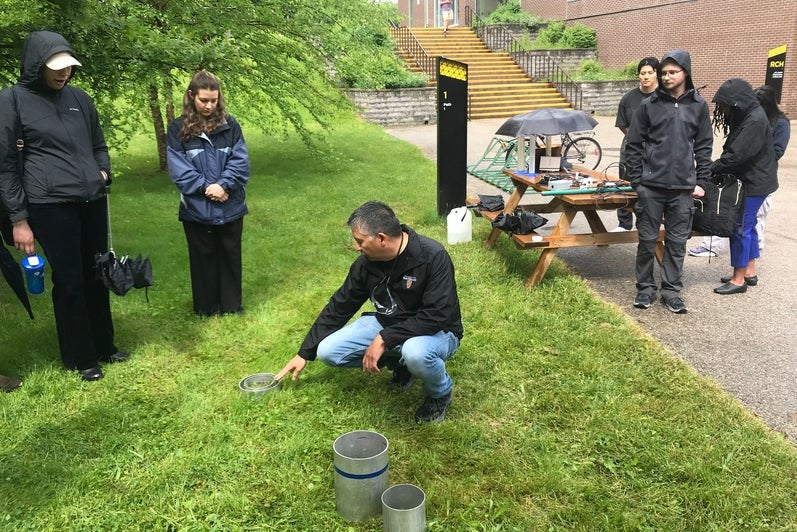 RISE team member demonstrating the stormwater hydrology instrumentation. 