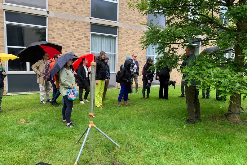 Participants observing a stormwater hydrology demonstration. 