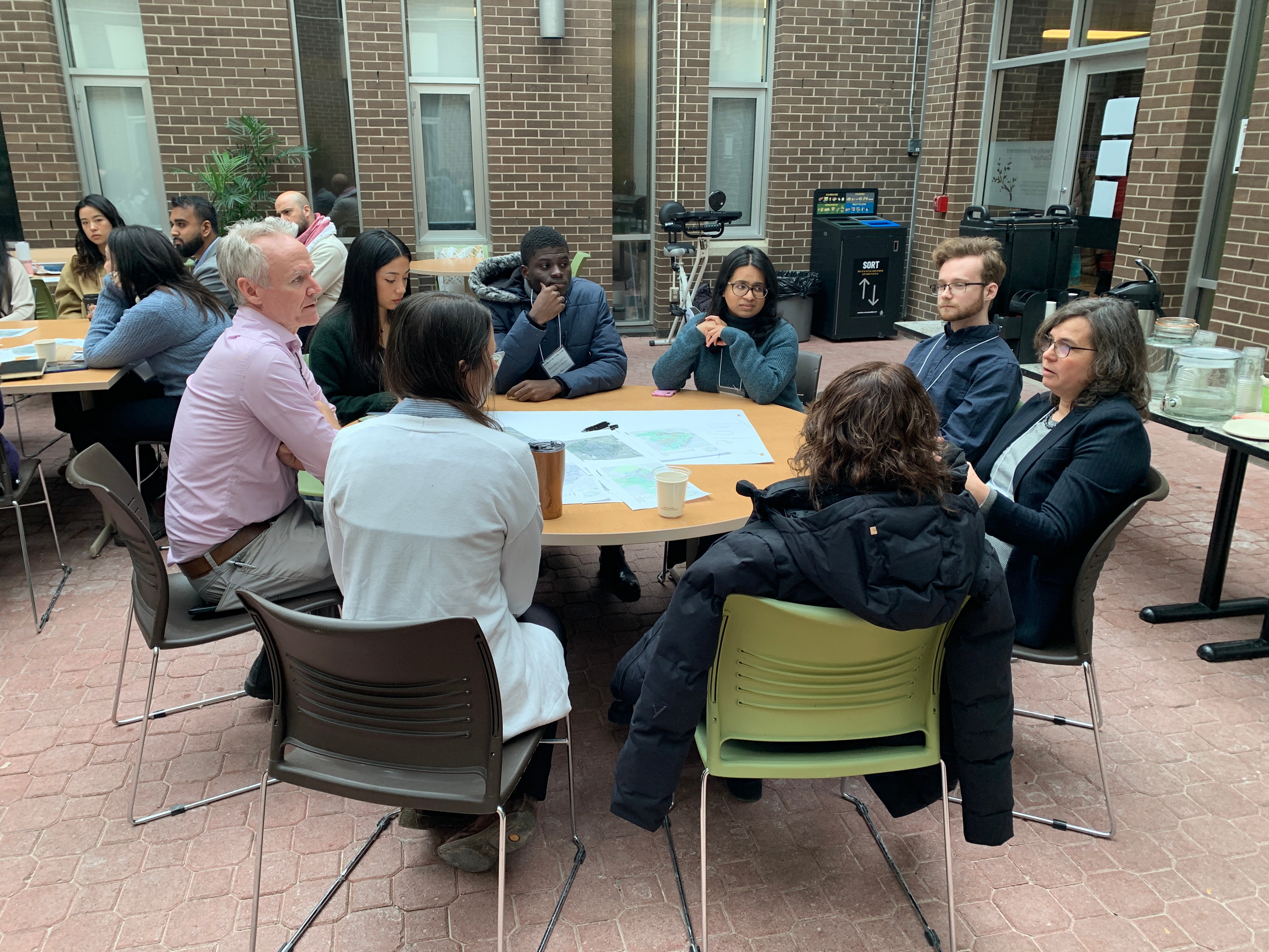 Participants sitting at round tables for the World Cafe activity.