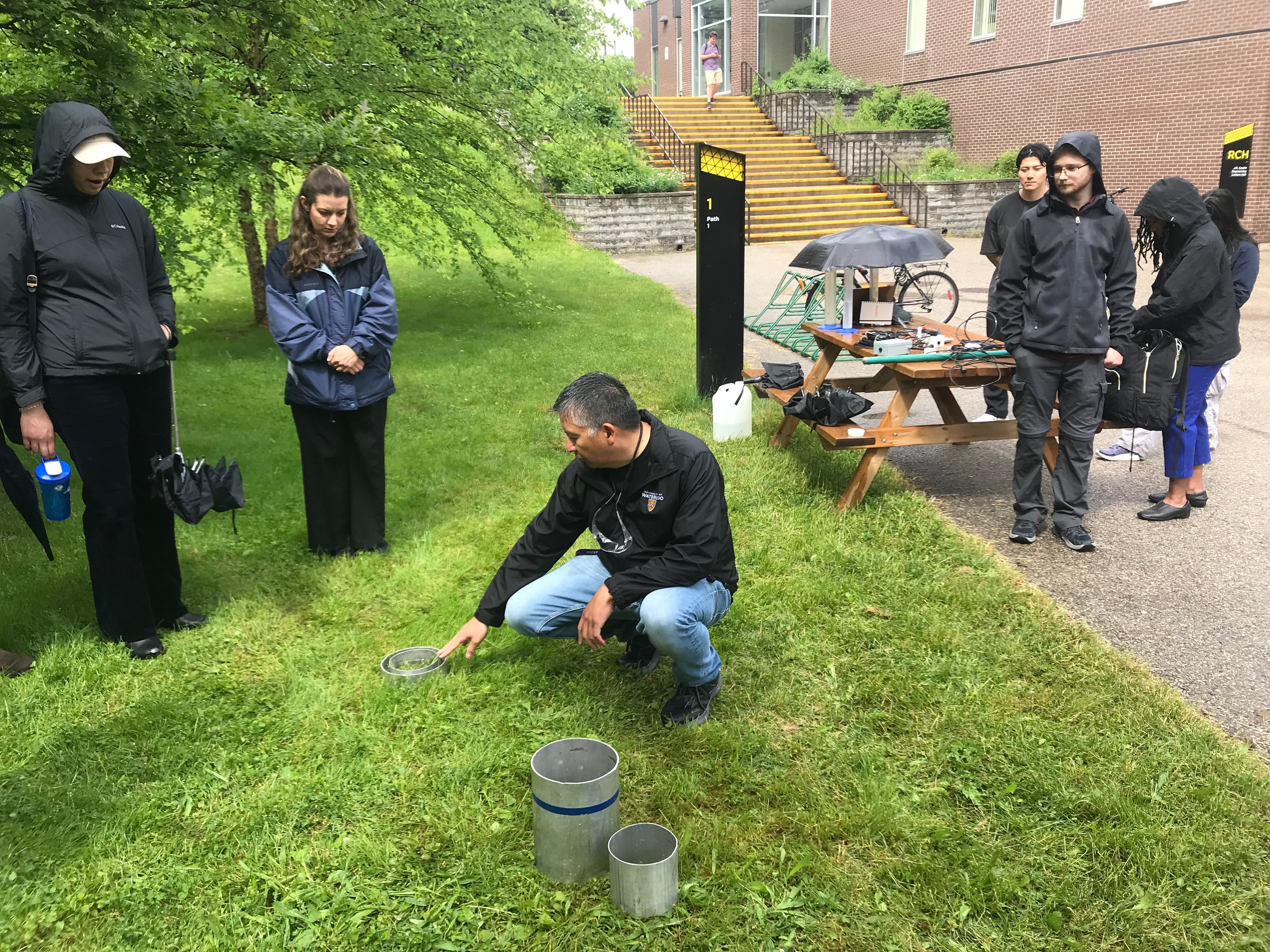 RISE team member demonstrating the stormwater hydrology instrumentation. 