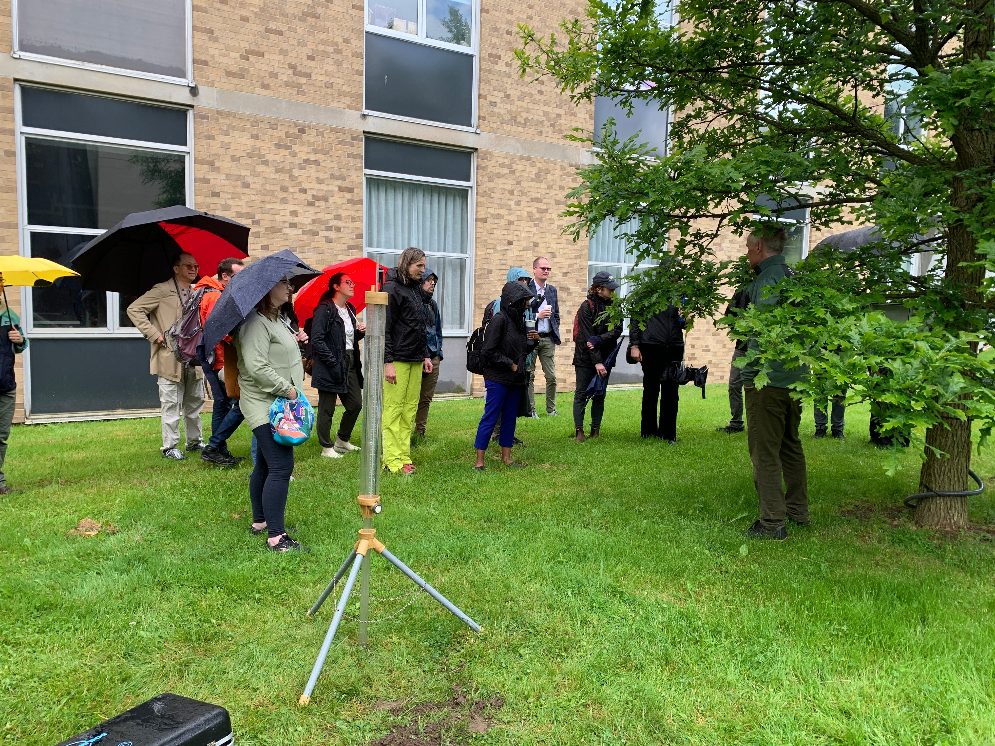 Participants observing a stormwater hydrology demonstration. 