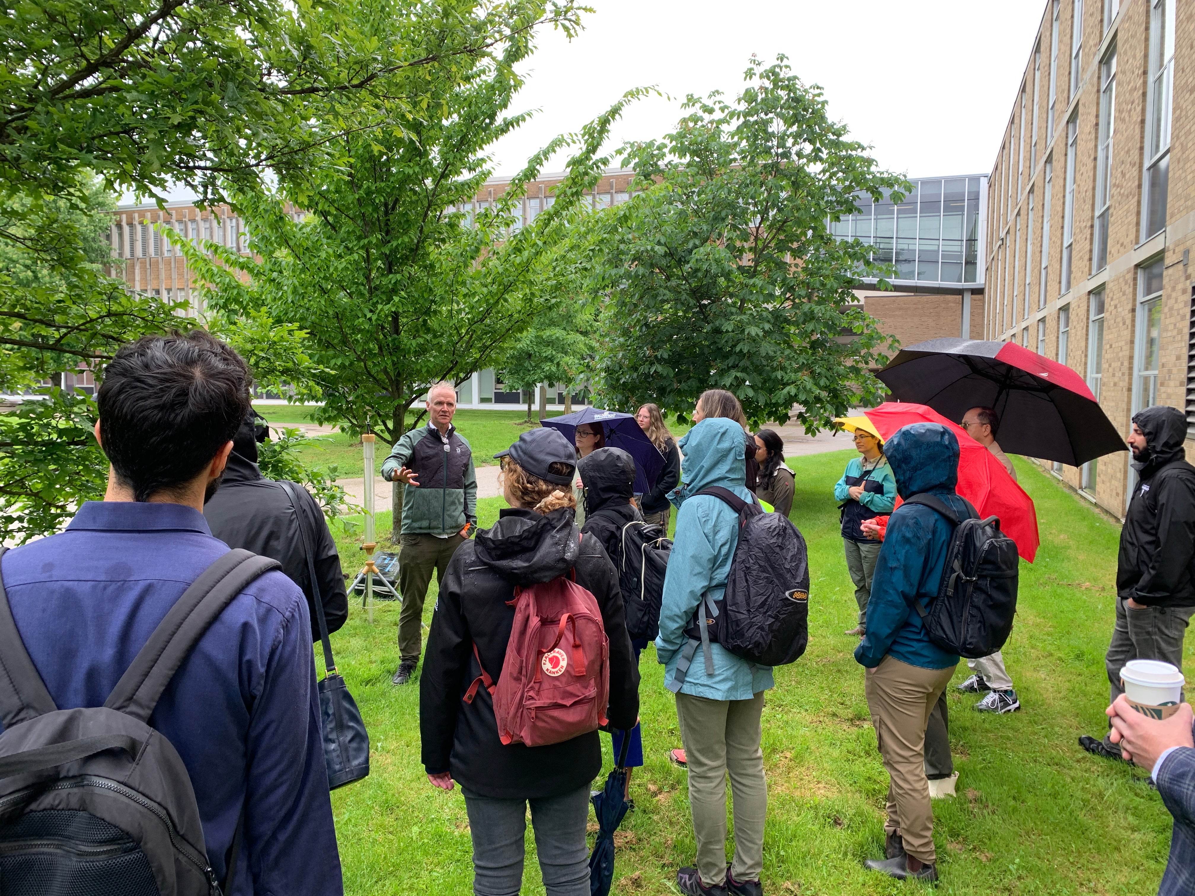 Participants observing the stormwater hydrology demonstration on campus.