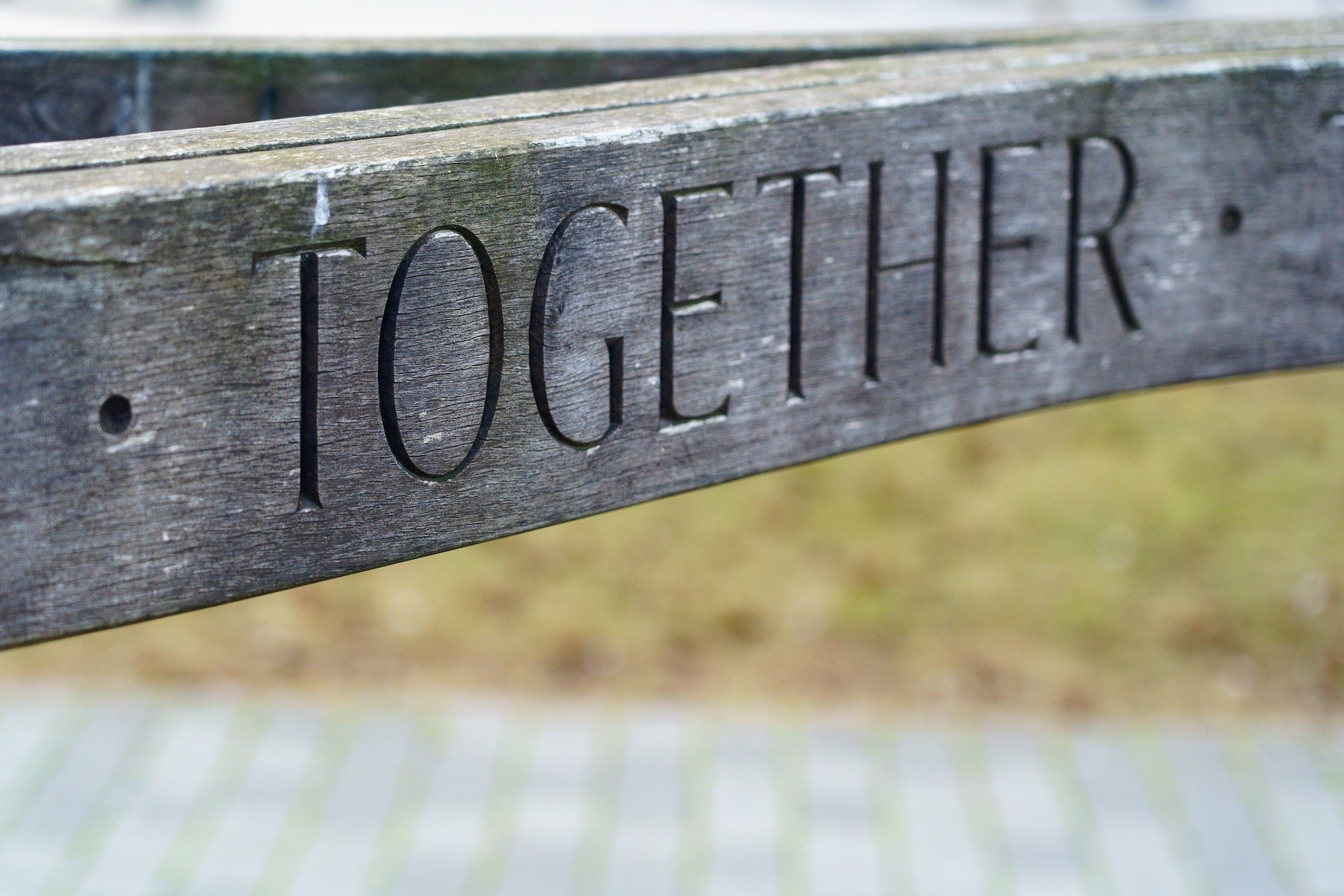 A wooden sign with the word "Together"