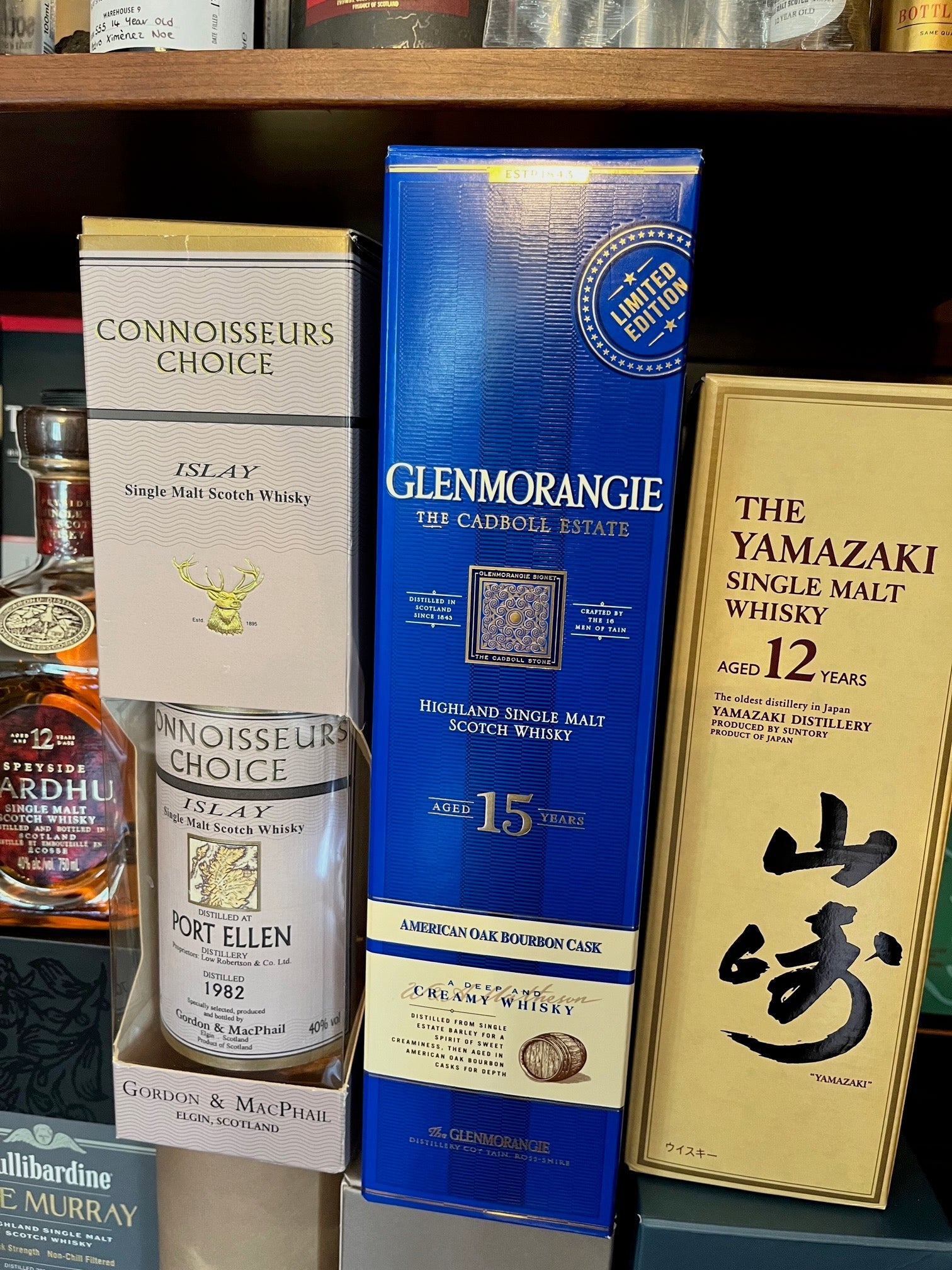 Three bottle of whisky on the shelf.