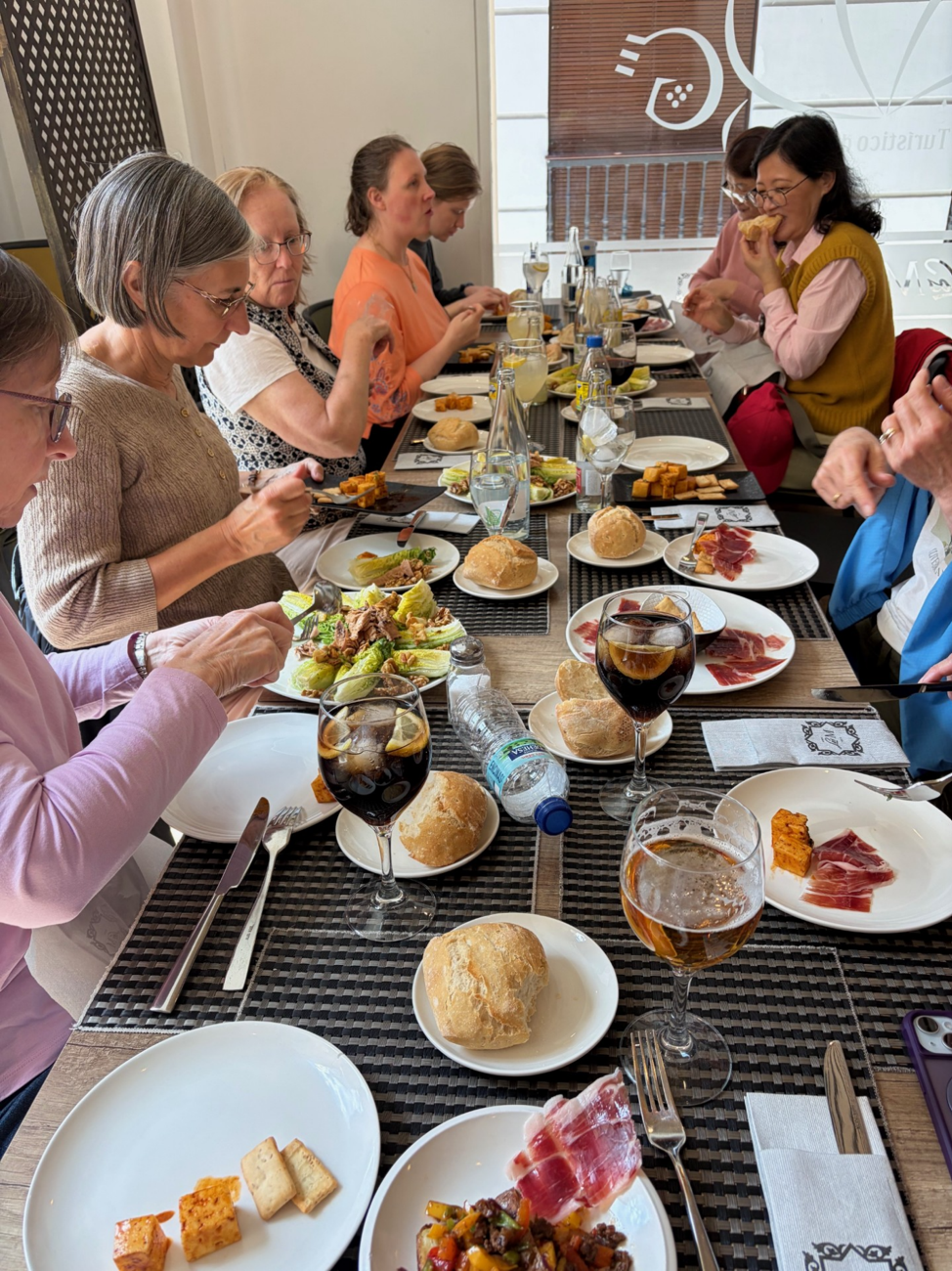 Family style meal for travellers in Spain.