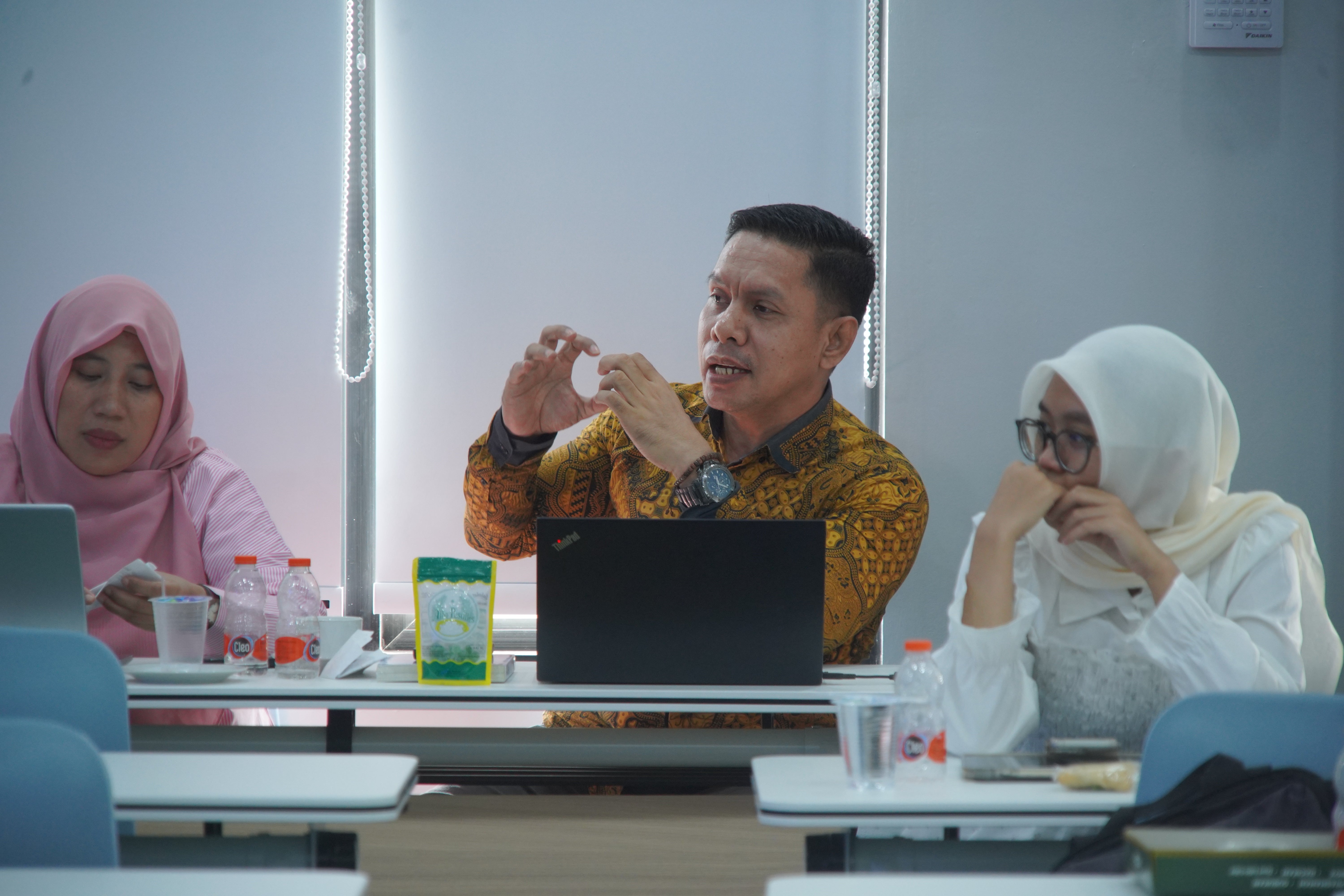 Person asking a question in a meeting
