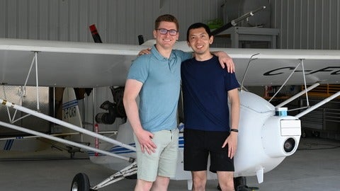 Ribbit partners standing in front of small plane