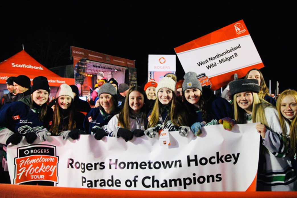 Group of girls celebrating with banner