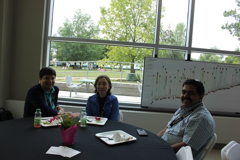 people smiling for picture at a table