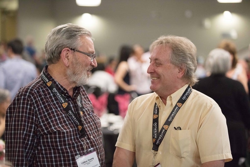 two men talking and laughing