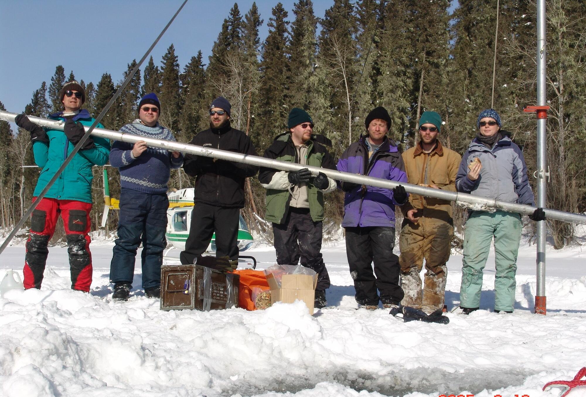Field crew holding a core from an oxbow lake in the Peace-Athabasca Delta in Alberta