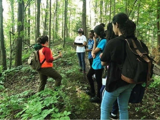 Aleks in the woods with students