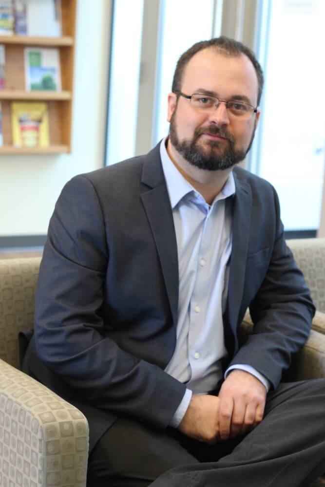 Sean Goebey sitting at his desk