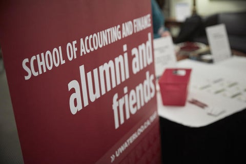Picture of a banner with the words "School of Accounting and Finance alumni and friends"