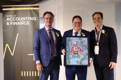 Troy Maxwell holds his framed print with SAF Director Blake Phillips and award presenter, Nick Tomovski