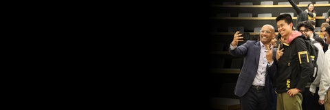 Benjie Thomas takes a selfie with a student