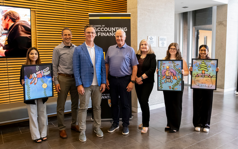 Blake Phillips receives prints of the Indigenous Mural he commissioned for SAF.