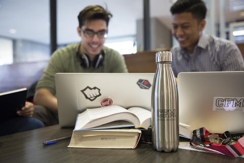 Two students working on laptops