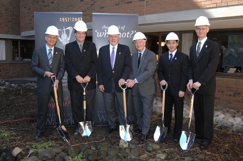 Members of SAF at the groundbreaking ceremony for the building in suits and holding shovels.