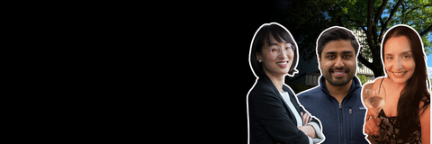 Three people standing outside in front of black gradient promotional material. 