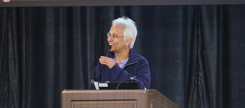 Ranjini Jha speaking at a podium