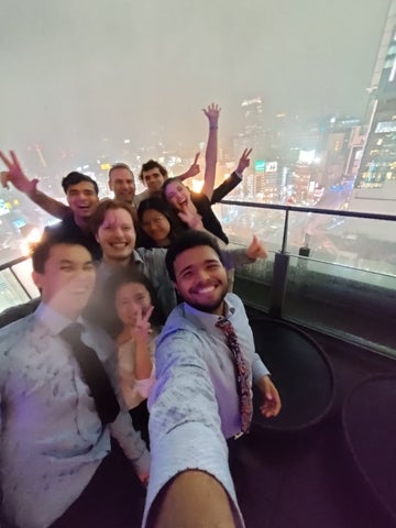 Students on a rooftop in the rain