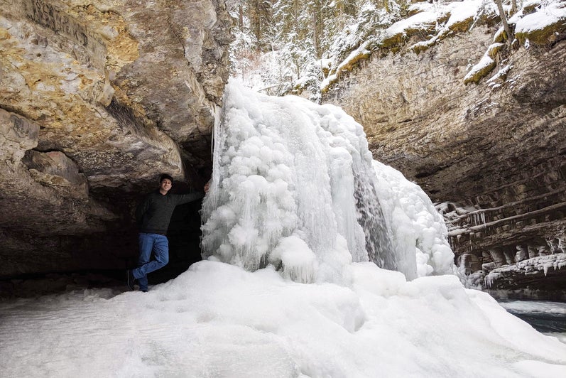 Shan standing beside frozen waterfall