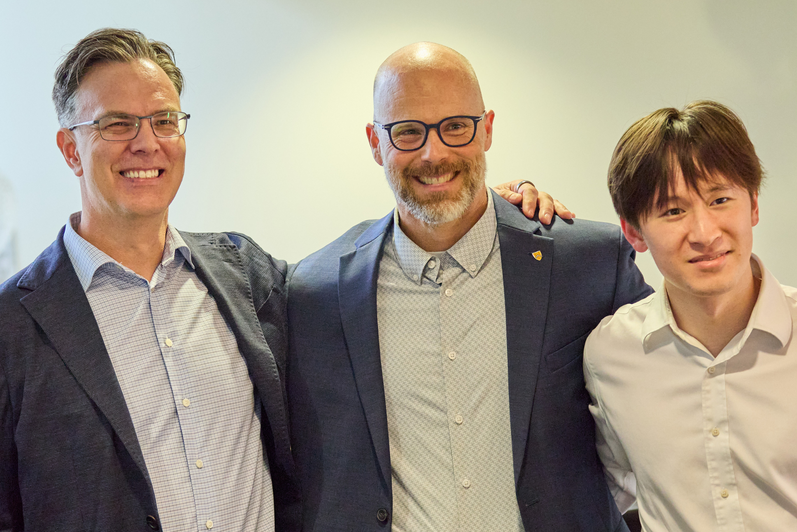 Blake Phillips and Michael wood pose for a photo with an SFM graduate.