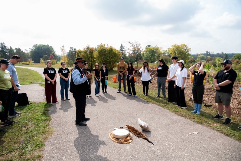 Elder Myeengun Henry, UWaterloo’s Indigenous Knowledge Keeper, addresses the crowd at the SFM tree planting event