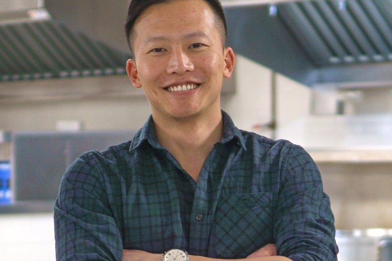 Ian Weng smiles in a kitchen