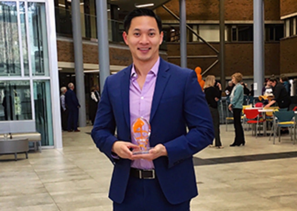 David Ha, holding Faculty Excellence in Teaching Award