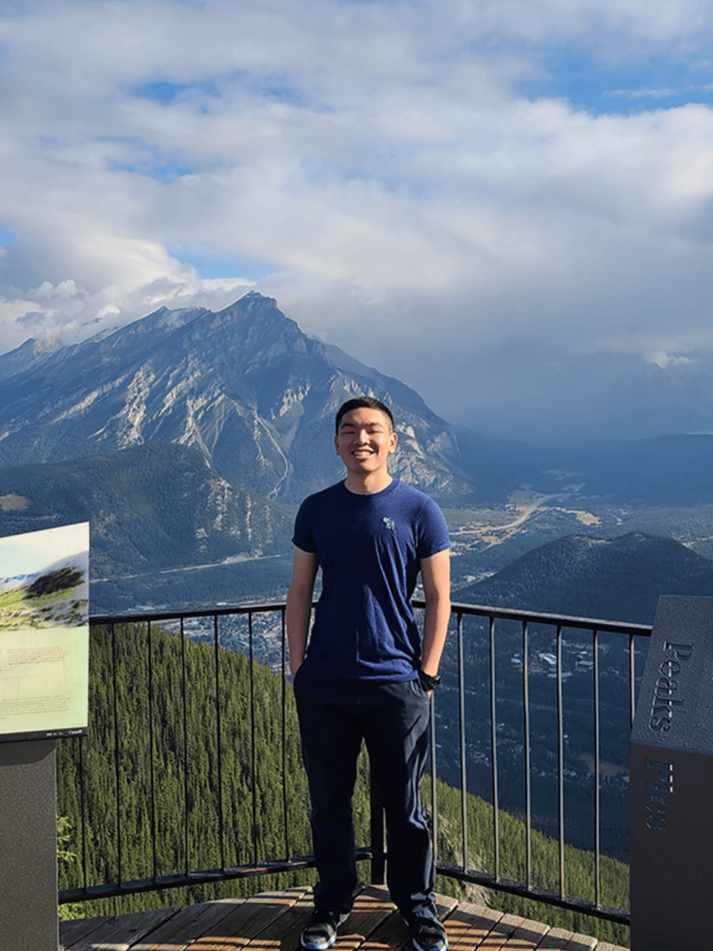 man standing against the backdrop of mountains 