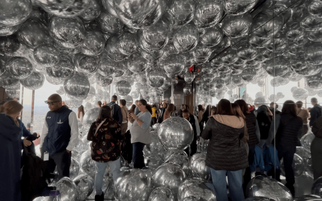 SUMMIT One Vanderbilt immersive room. Round mirrored structures cover all surfaces of the room.