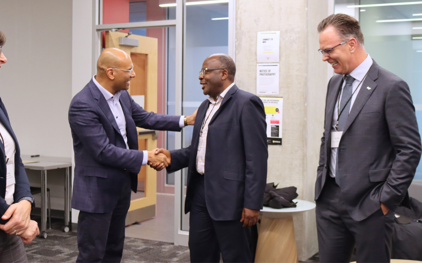 Benjie Thomas shaking hands with Alexie Tcheuyap and Blake Philips